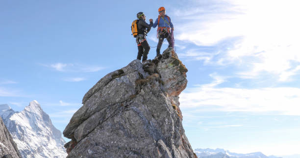 istock Mountaineers high five on mountain summit 1331838753