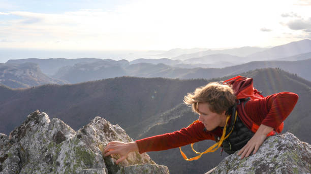 istock Mountaineer climbs up to mountain summit 1331838890