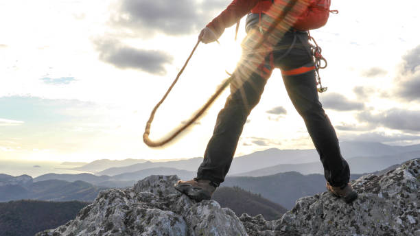 istock Mountaineer organises rope on mountain summit 1331839027
