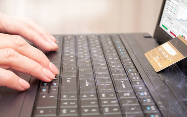 istock Notebook, credit card and hands on laptop keyboard. Concept of e-commerce, electronic payments and remote work 1331839696