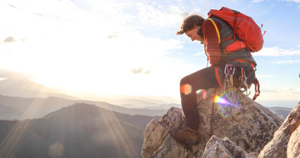 istock Mountaineer climbs up to mountain summit 1331839725