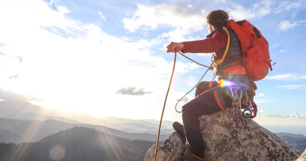 istock Mountaineer climbs up to mountain summit 1331839740