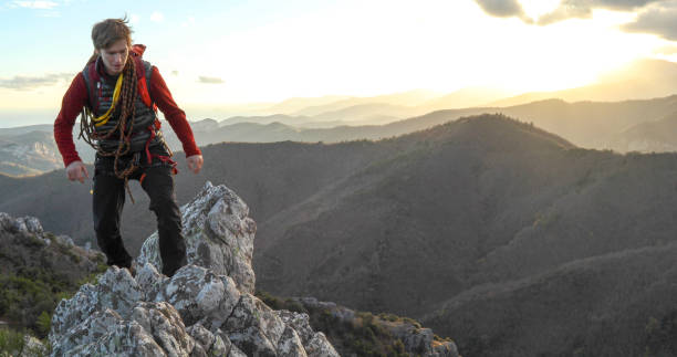 istock Mountaineer climbs up to mountain summit 1331839829