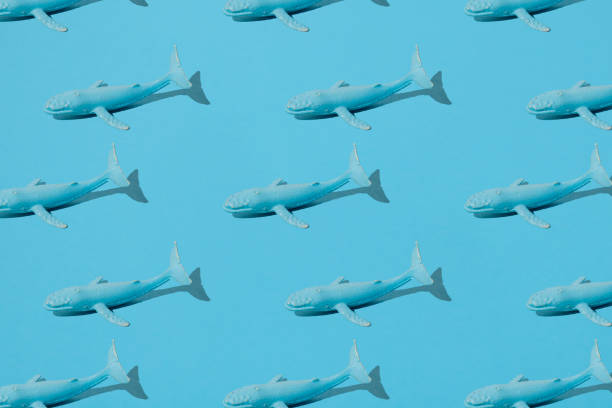 istock Blue whales rubber toy on blue background. Minimal pattern. 1331839916