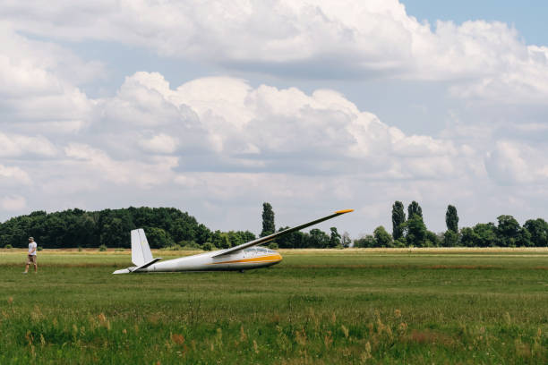 istock Man preparing and checking glider parked in the field 1331840055