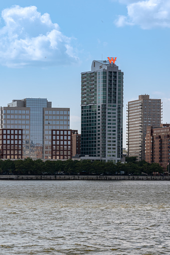 Hoboken, NJ - USA - July 30, 2021: Vertical view of the Hoboken waterfront, featuring the W Hoboken Hotel and Hudson River Waterfront Walkway.
