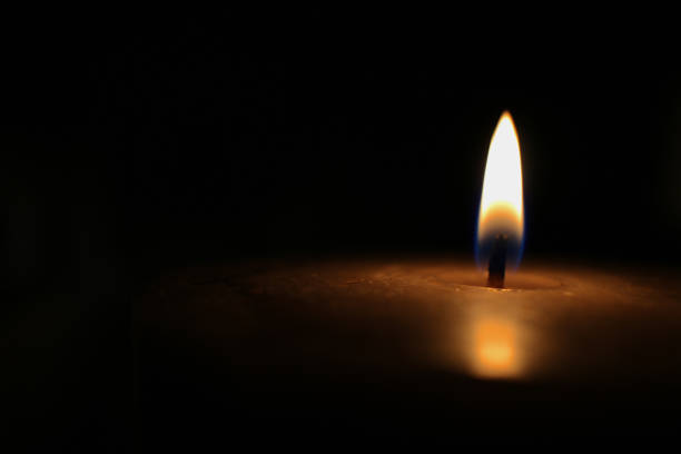 istock Burning flame of candle on black background 1331842837