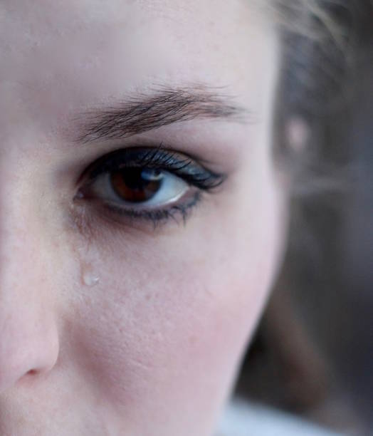 istock Closeup teardrop on woman's face 1331842846
