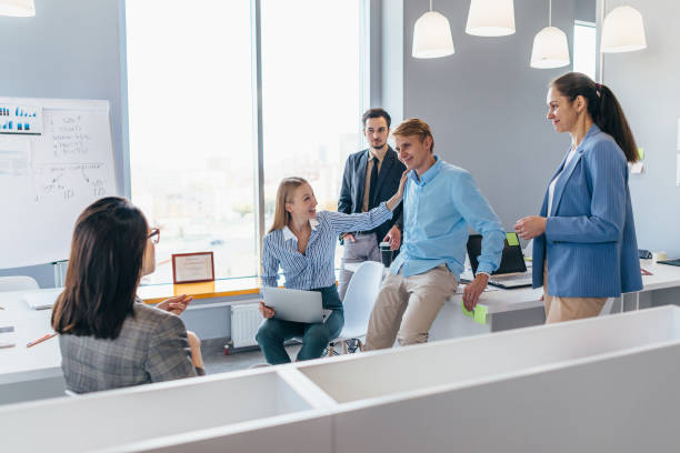 istock Colleagues lively discuss business issues together in the office 1331844790