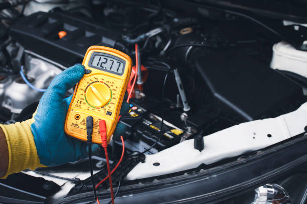 Technician checking DC voltage stable with digital multimeter Technician checking DC voltage stable of the car battery with digital multimeter multimeter stock pictures, royalty-free photos & images