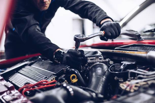 istock Mechanic in service repairing engine with wrench 1331850405
