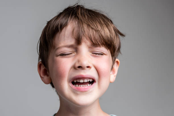 istock Crying caucasian little boy On gray background 1331851381