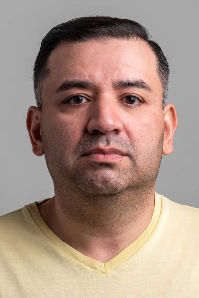 istock Serious mature man looking at the camera on gray background 1331854531