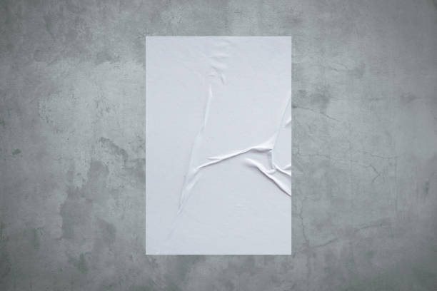 istock Blank white wheatpaste glued paper poster mockup on concrete wall background 1331856083