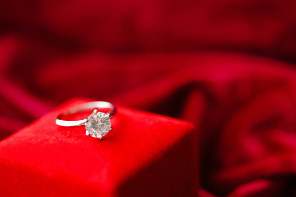 istock Diamond ring with jewelry gift box on red fabric background 1331856175