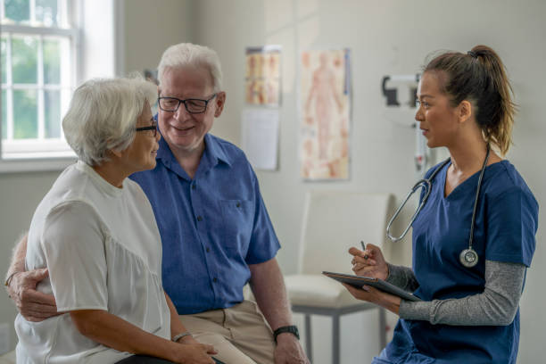 istock Elderly couple discusses with nurse 1331856533