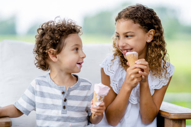 istock Siblings enjoying ice cream cones 1331856652