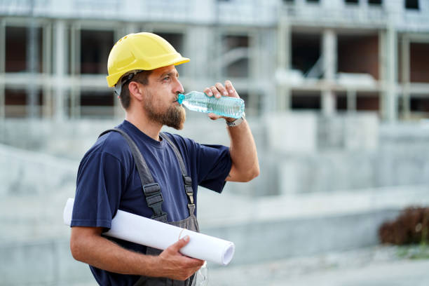 istock Portrait of construction worker resting and drinking water after hard work on a construction site 1331856722
