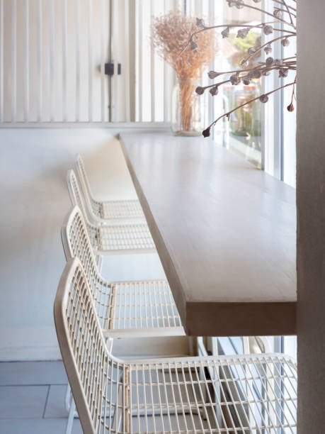 istock Cafe with simply interior design with a row of empty modern white wire chairs. 1331863757