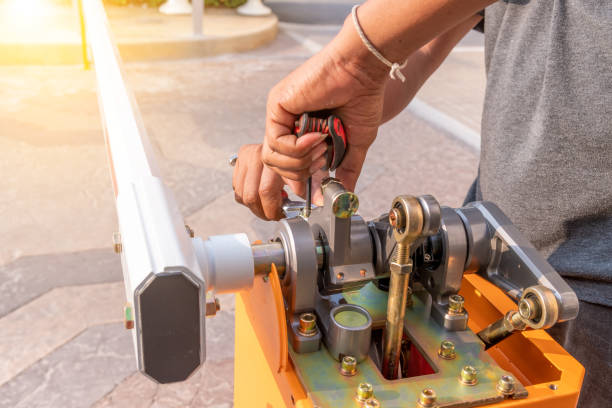 istock Technician under assemble barrier door gate security system ,technology automated closed and open entrance way of building or condominium ,security system concept. 1331871230
