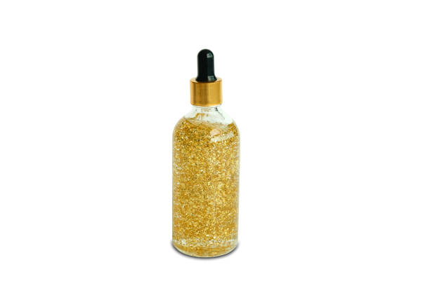 istock Serum collagen moisturizer of face into clear gold bottle soft light background. Protector skin Treatment facial essence oil, Vitamin C. Beauty and spa Concept 1331871986