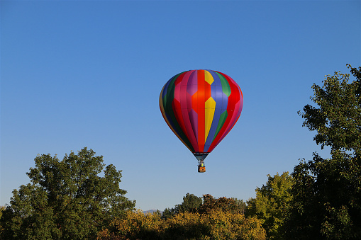 Colorful hot air balloons flying in the blue sky with white clouds