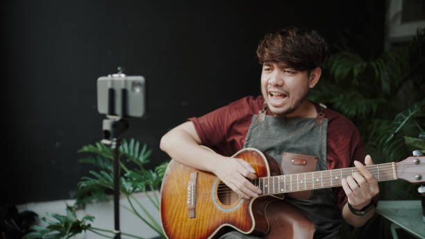 istock Asian man playing music together through a video call on the internet 1331873110