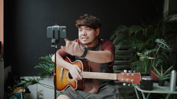 istock Asian man playing music together through a video call on the internet 1331873113