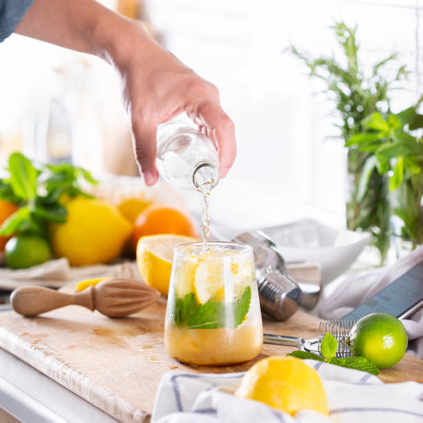 istock Mixologist making refreshing cocktail with hard seltzer at home 1331874022