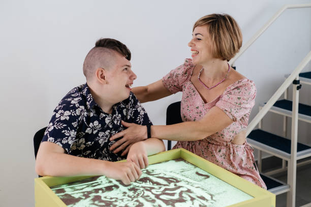 istock disabled child doing sensory activity with sand, rehabilitation 1331875057