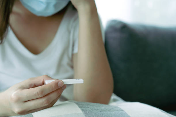 istock Woman using COVID-19 ag test kit. 1331878466
