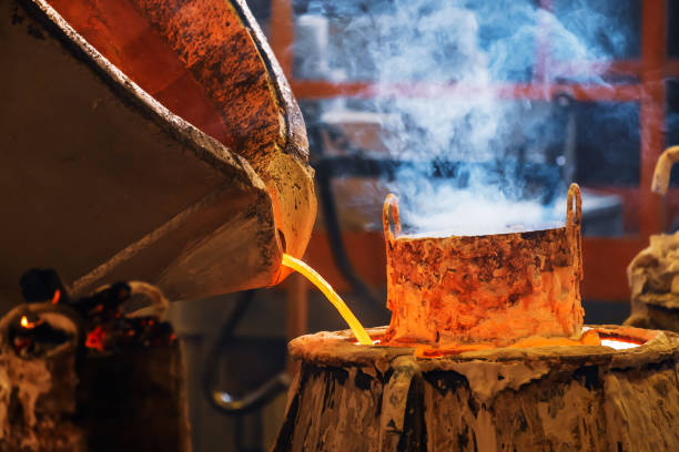 istock pouring molten red metal into a mold from which smoke is emitted 1331879417