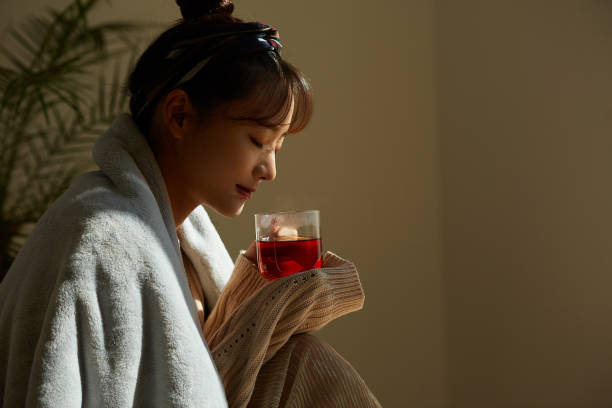 istock A young Asian woman relaxing at home drinking fruit tea 1331879429