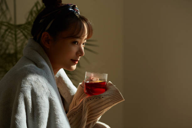 istock A young Asian woman relaxing at home drinking fruit tea 1331879450