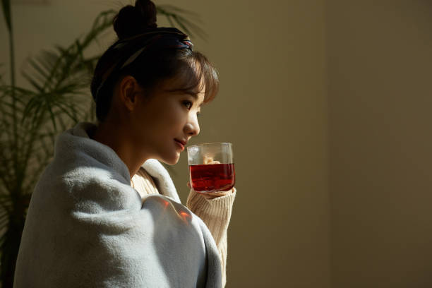 istock A young Asian woman relaxing at home drinking fruit tea 1331879554