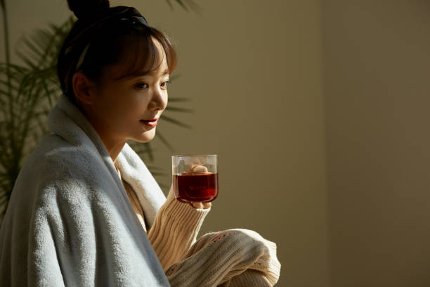 istock A young Asian woman relaxing at home drinking fruit tea 1331879625