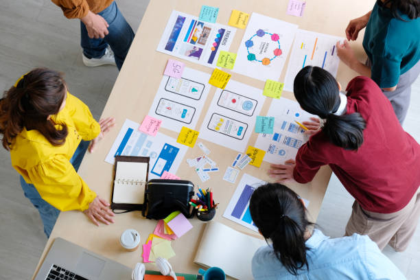 istock Brainstorm planing creative asian teamwork, Group of asia mobile phone app developer team meeting for ideas about screen display prototype smartphone layout, ux startup small business, top view 1331879646