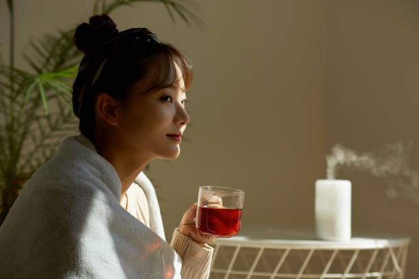 istock A young Asian woman relaxing at home drinking fruit tea 1331879726