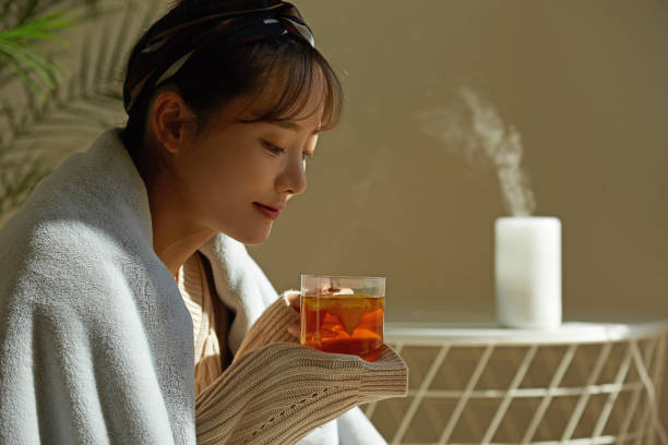 istock A young Asian woman relaxing at home drinking fruit tea 1331880541