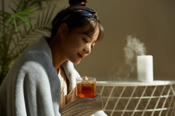 istock A young Asian woman relaxing at home drinking fruit tea 1331880542