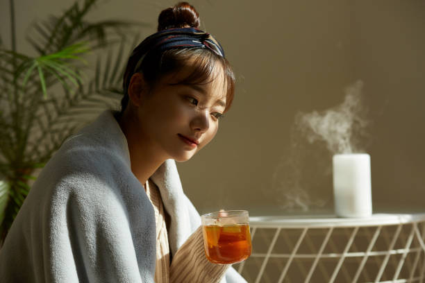 istock A young Asian woman relaxing at home drinking fruit tea 1331880543