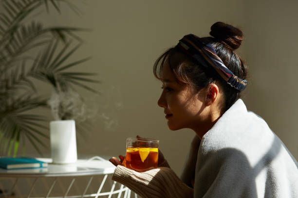 istock A young Asian woman relaxing at home drinking fruit tea 1331880668