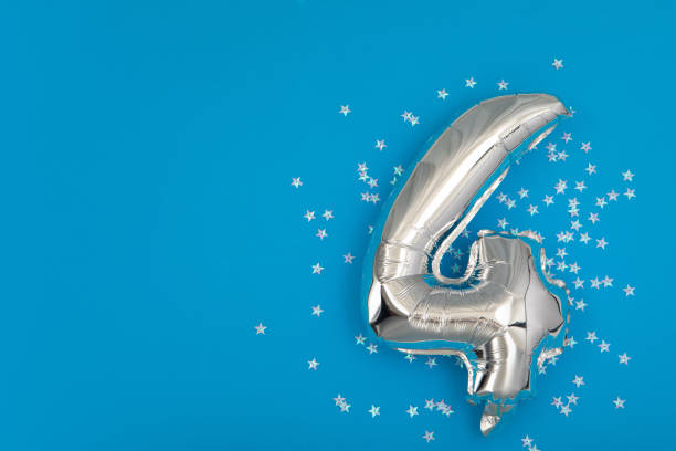 istock Silver balloon 4 on a blue background with confetti stars 1331881301