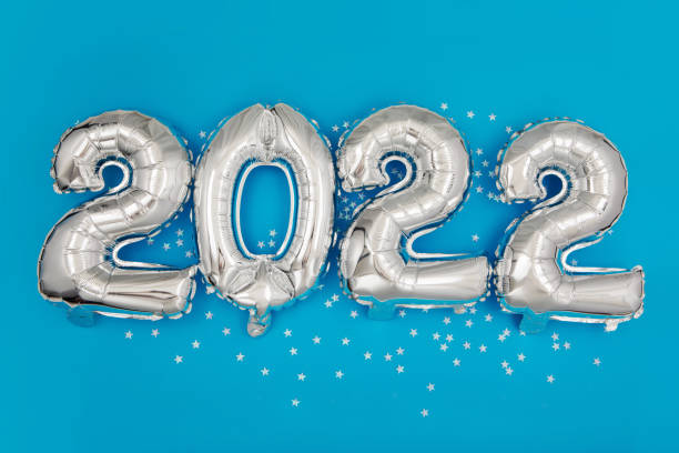 istock Silver balloons showing 2022 year on blue background 1331881304