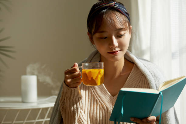 istock A young Asian woman relaxing at home drinking fruit tea 1331881392
