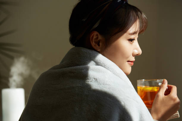 istock A young Asian woman relaxing at home drinking fruit tea 1331881393
