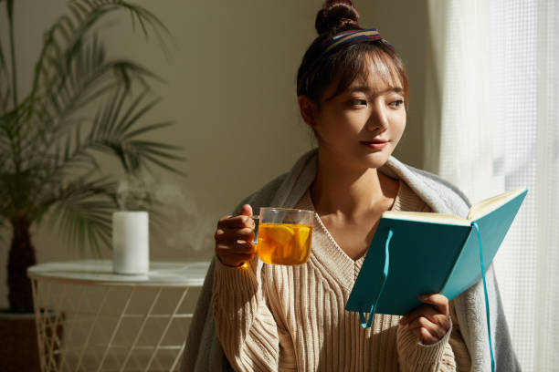 istock A young Asian woman relaxing at home drinking fruit tea 1331881515
