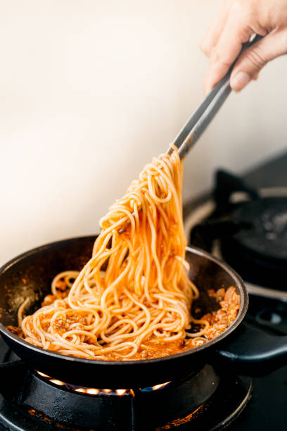 istock Tomato pasta is cooked in a frying pan on the kitchen background 1331881531