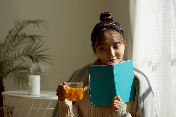 istock A young Asian woman relaxing at home drinking fruit tea 1331881558