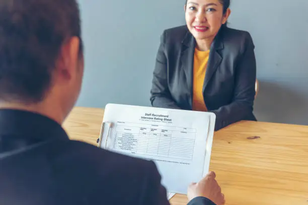 Job Interview HR human resource manager interviewing new employee candidate look at CV Resume asking job requirement question at business firm office desk. Job Interview headhunter agent application